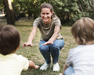 Lehrerin zeigt eine Kniebeuge vor